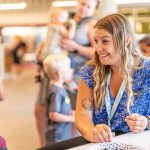 Smiling adult spends time with child at Families First Learning Lab