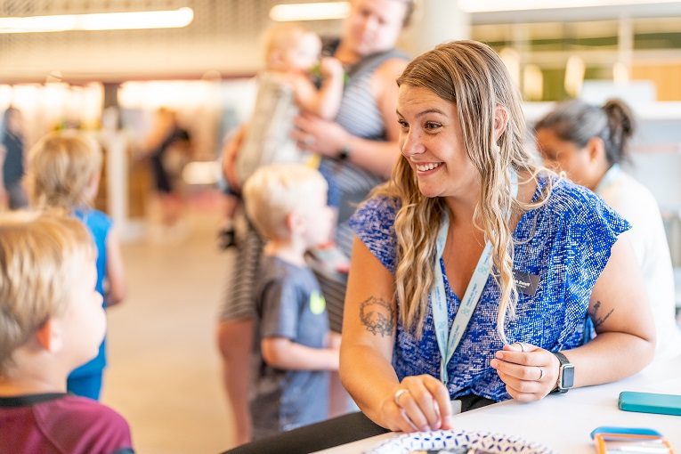 Smiling adult spends time with child at Families First Learning Lab