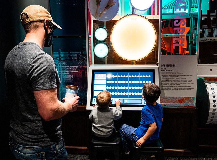 Father and two sons enjoy the new Spark exhibit at The Bakken Museum