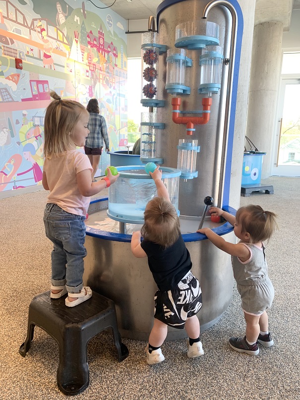 Kids play with an interactive exhibit at Families First Learning Lab