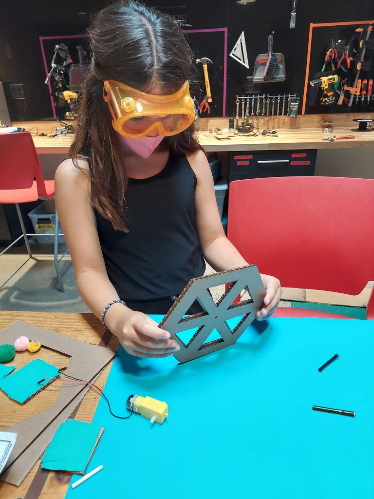 Young girl learns about ferris wheel engineering