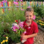 Kids Ranch Inc. youth holds flowers picked from a therapeutic garden