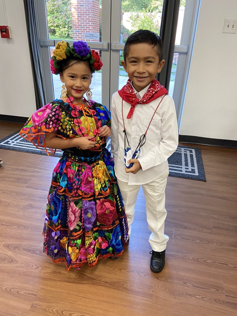 Two young Folklorico dancers in costume at Los Niños Primero