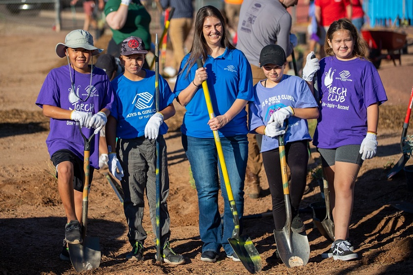 Watters plants alongside the kids