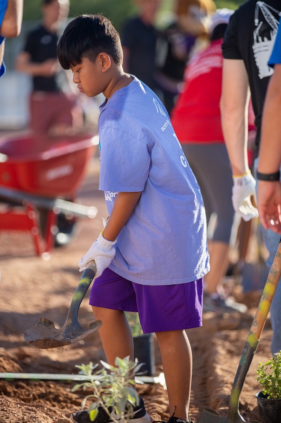 hispanic boy plants during Boys and Girls Clubs of Tucson doolen planting event