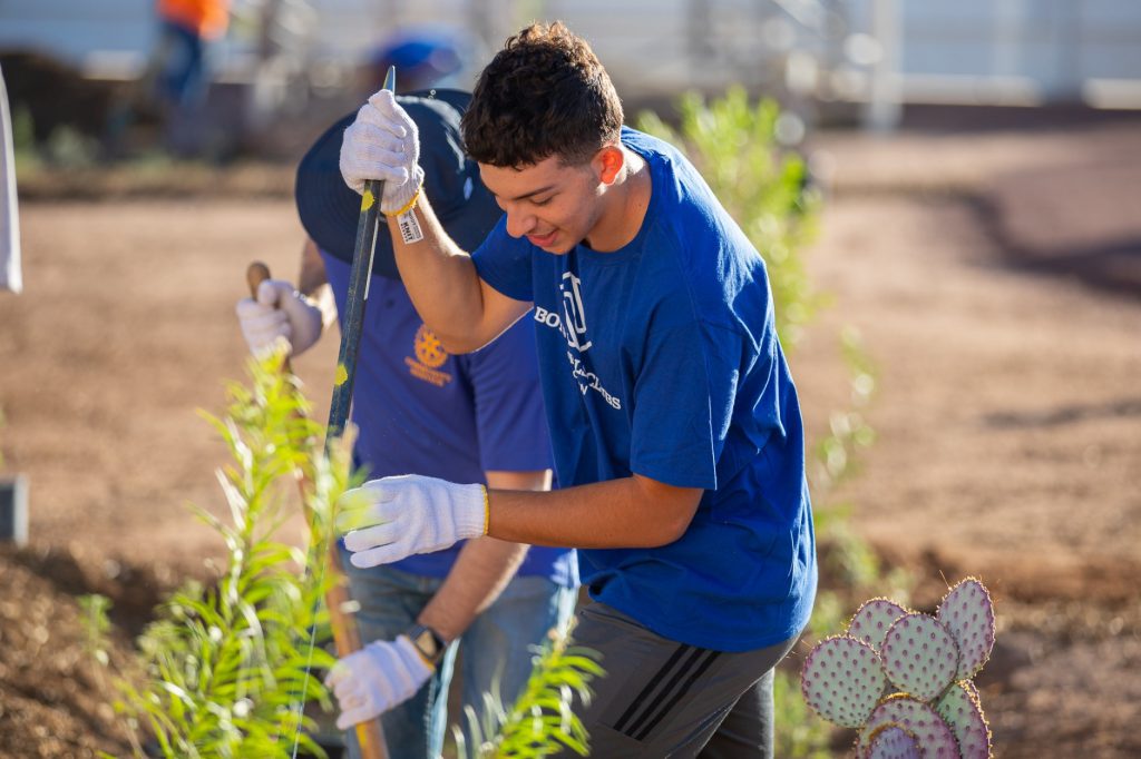 smiling youths plant during Boys and Girls Clubs of Tucson doolen planting event