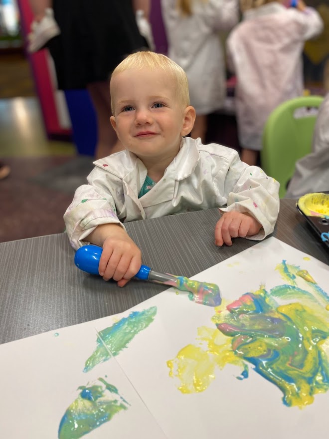 little boy paints at LaunchPAD