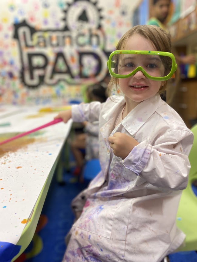 girl plays scientist at LaunchPAD children's museum