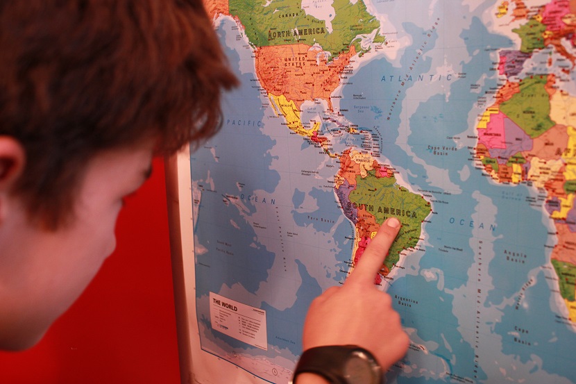 clonlara school boy points at country on map geography