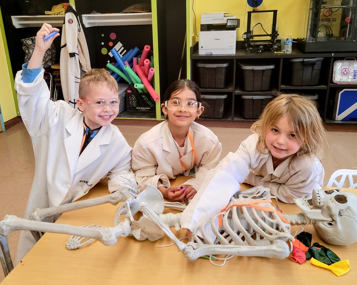 Bisbee kids play doctor in coats with skeleton