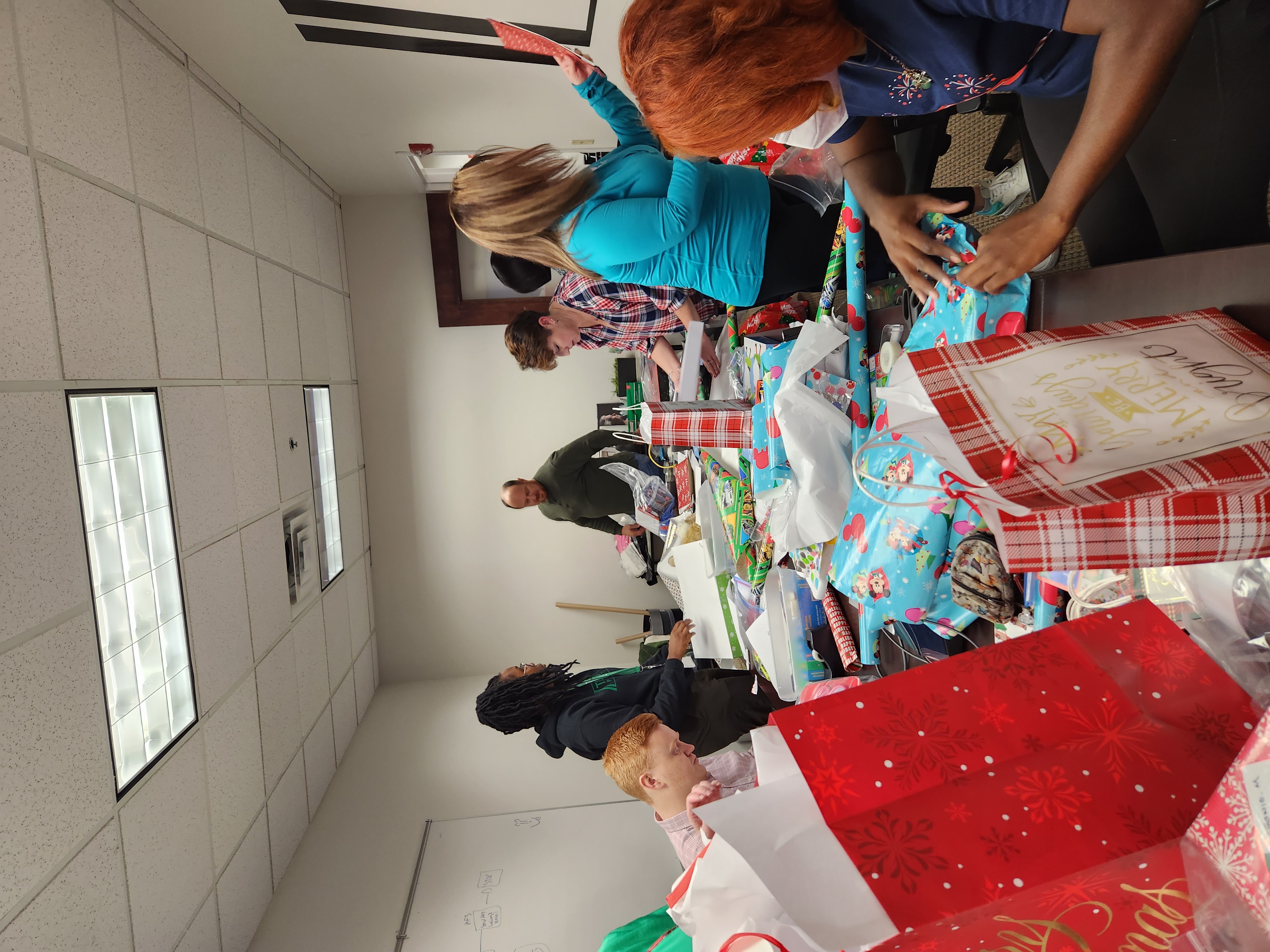 Volunteers wrap gifts for the children.