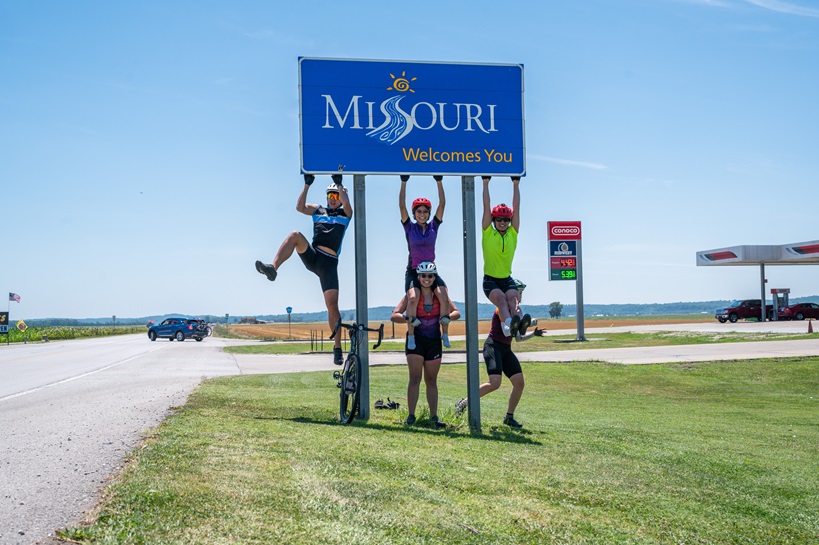 MIT Spokes team playfully climbs Missouri sign