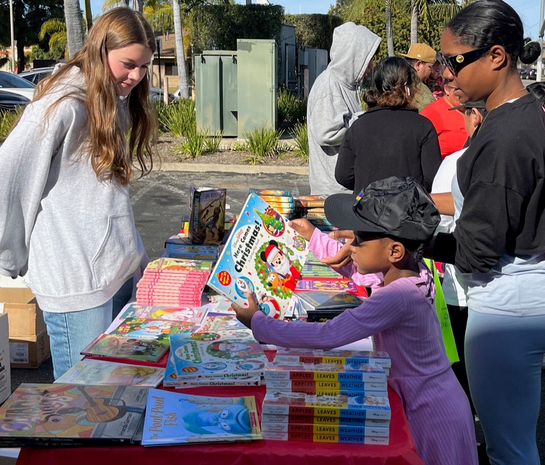 Child looks at book at book fair