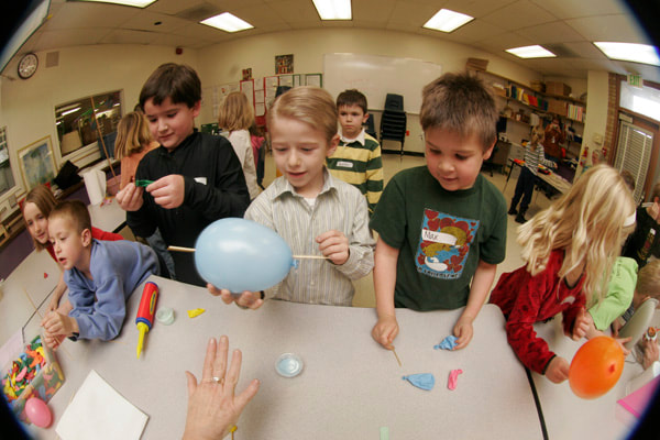 boys pop balloons cool science activity