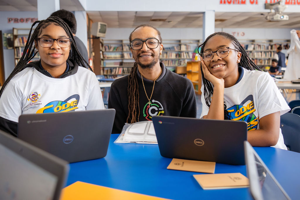 CodeCrew tutoring session, 2 black teens with black tutor, smiling