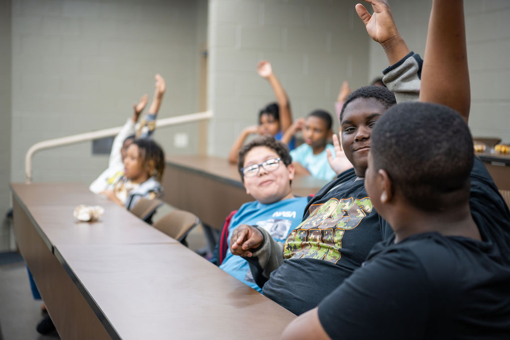 CodeCrew kids raise hands