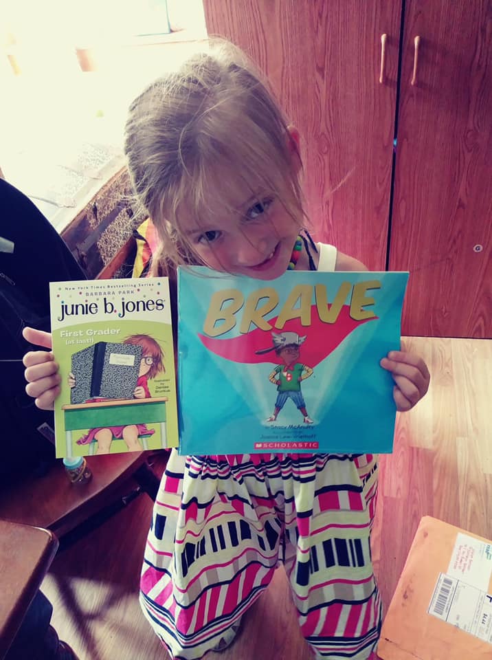 Onalee with her self-selected books from Kids Read Now.