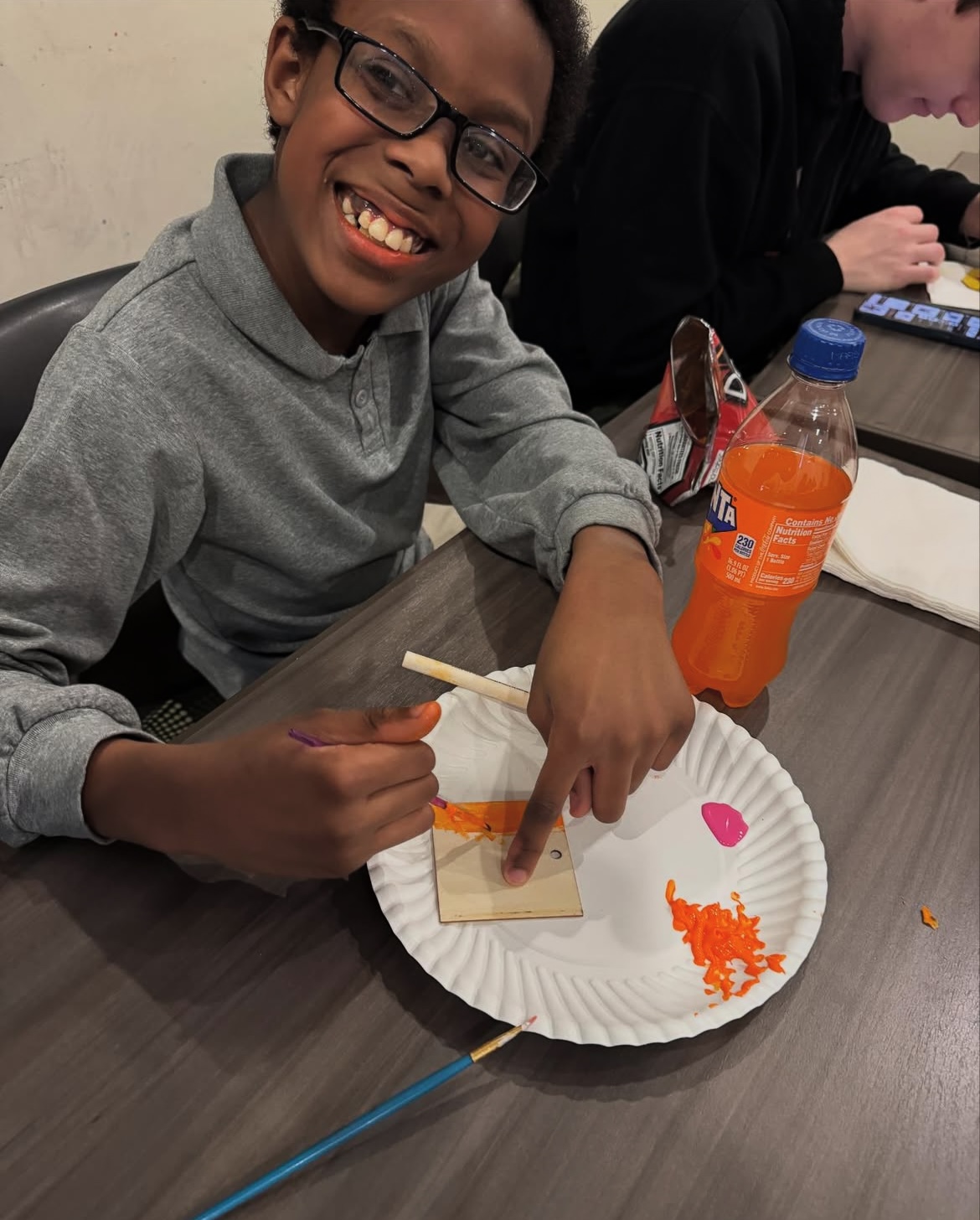 College Mentors for Kids youngster engaged in handicraft