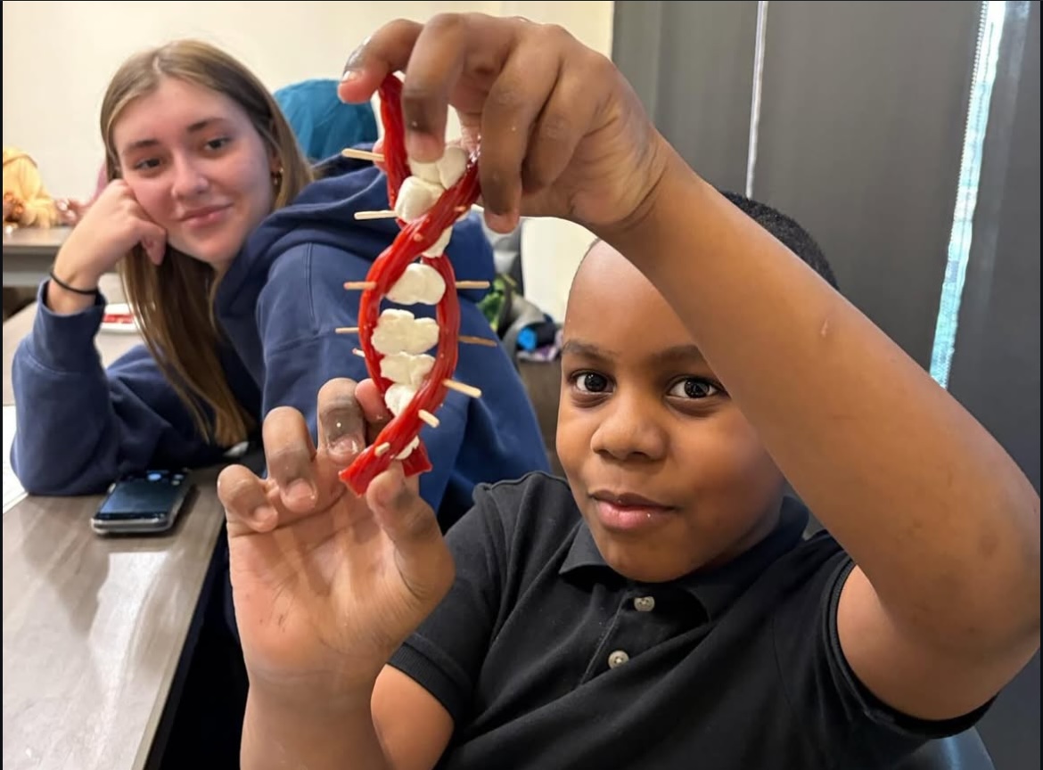 College Mentors for Kids child holds DNA model