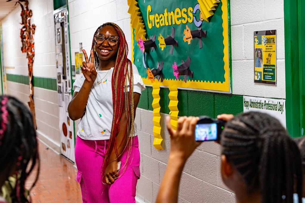 Happy African American teen at head of classroom at The Village Group