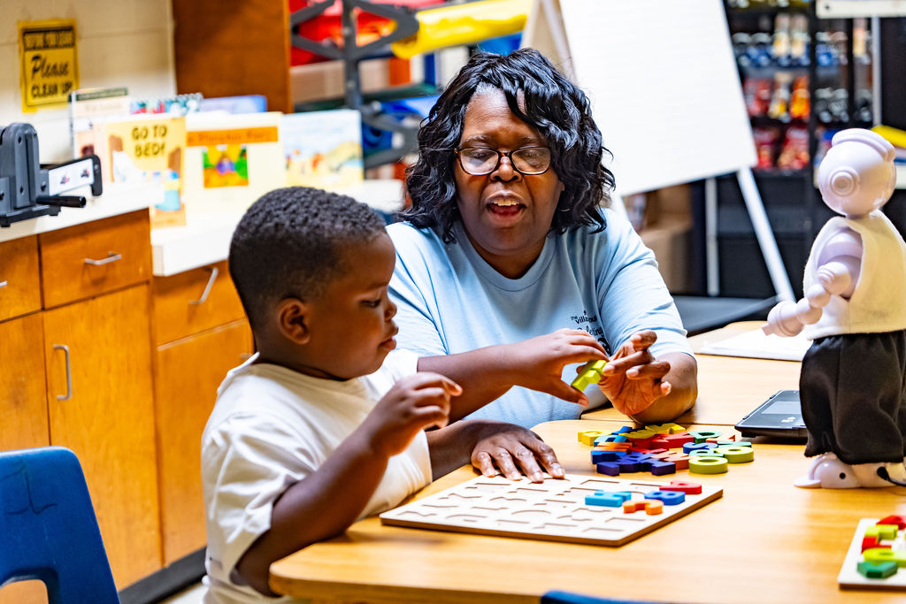 Tutor works with youngster during after school program at The Village Group