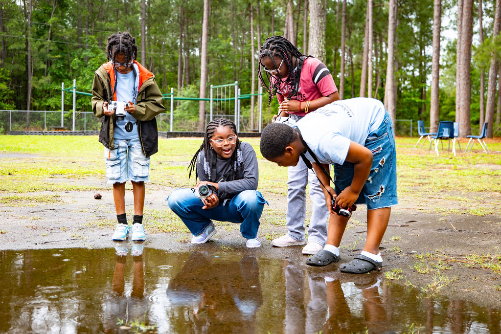 The Village Group kids study a small pond