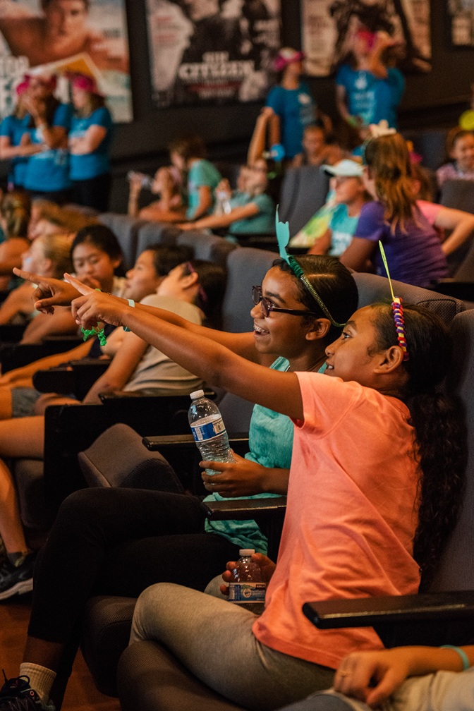 seated pointed smiling auditorium