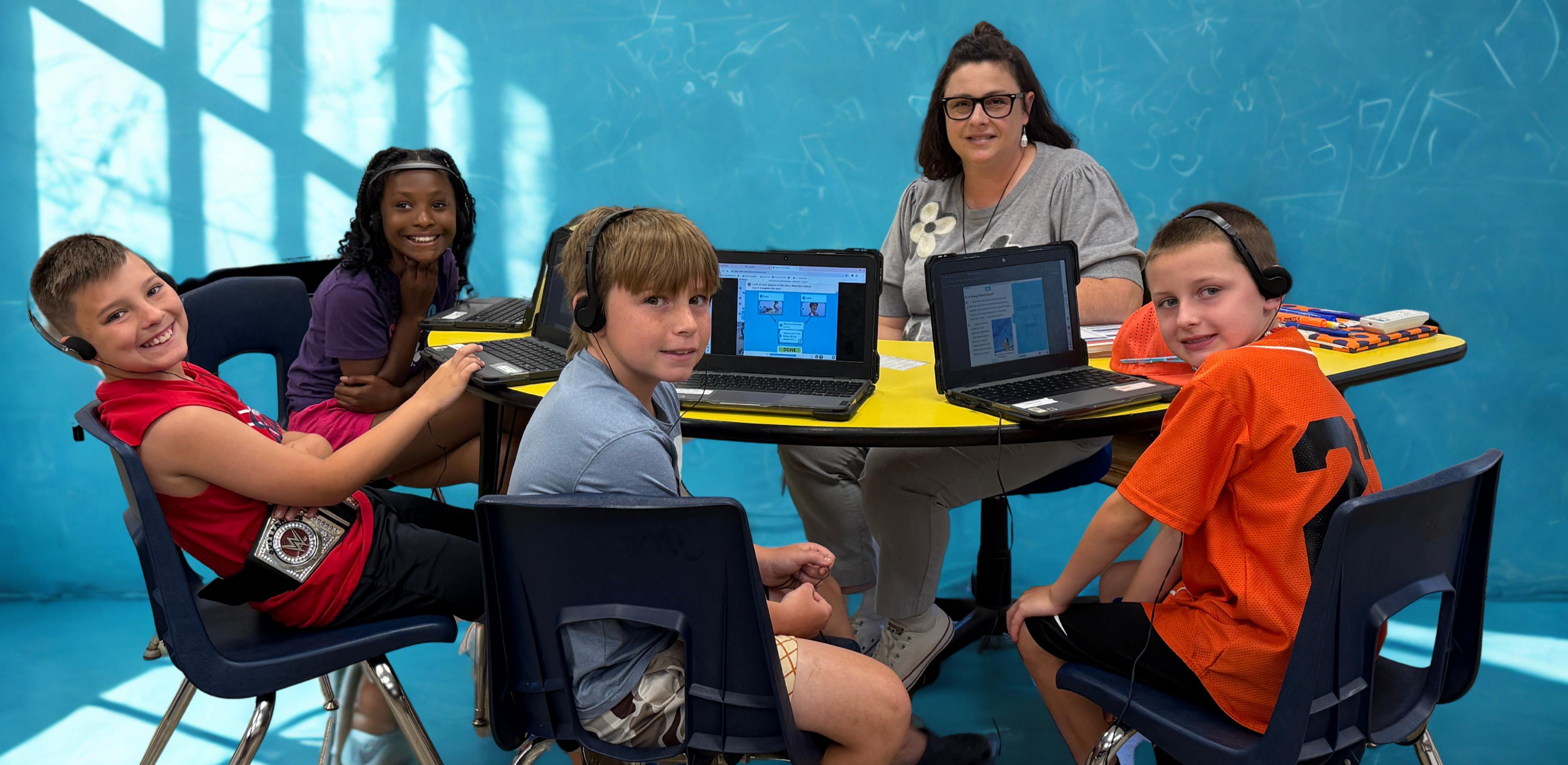 Camp iRock students at table with teacher