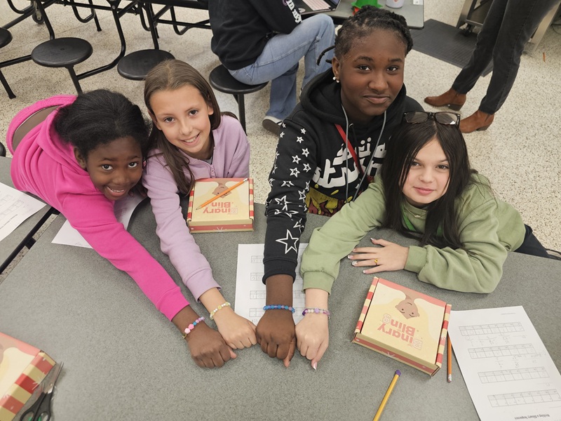 Dottie Rose Foundation, four girls, show binary code bracelets