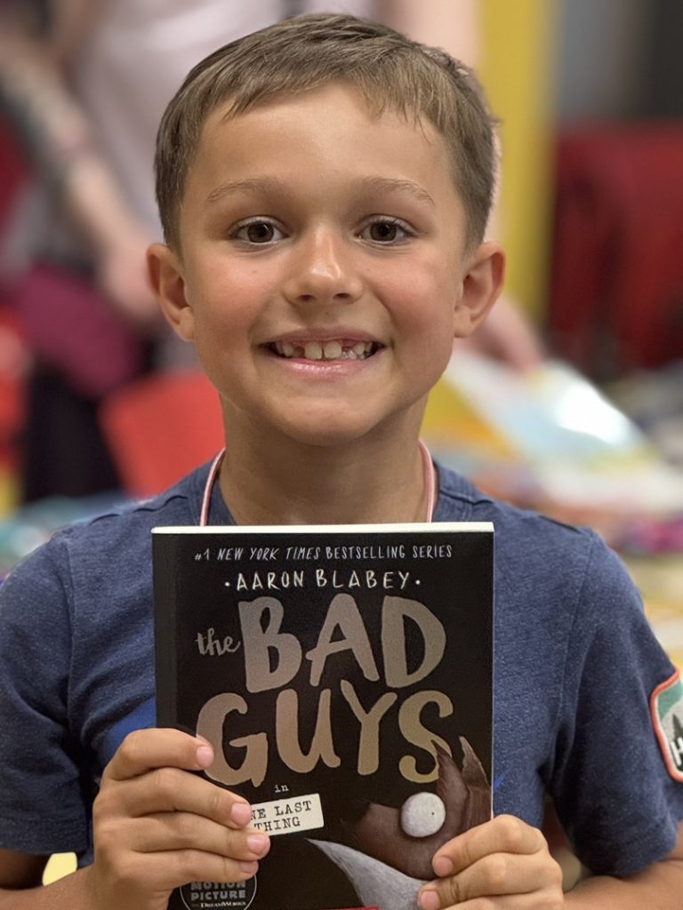 AR Kids Read student proudly holds book