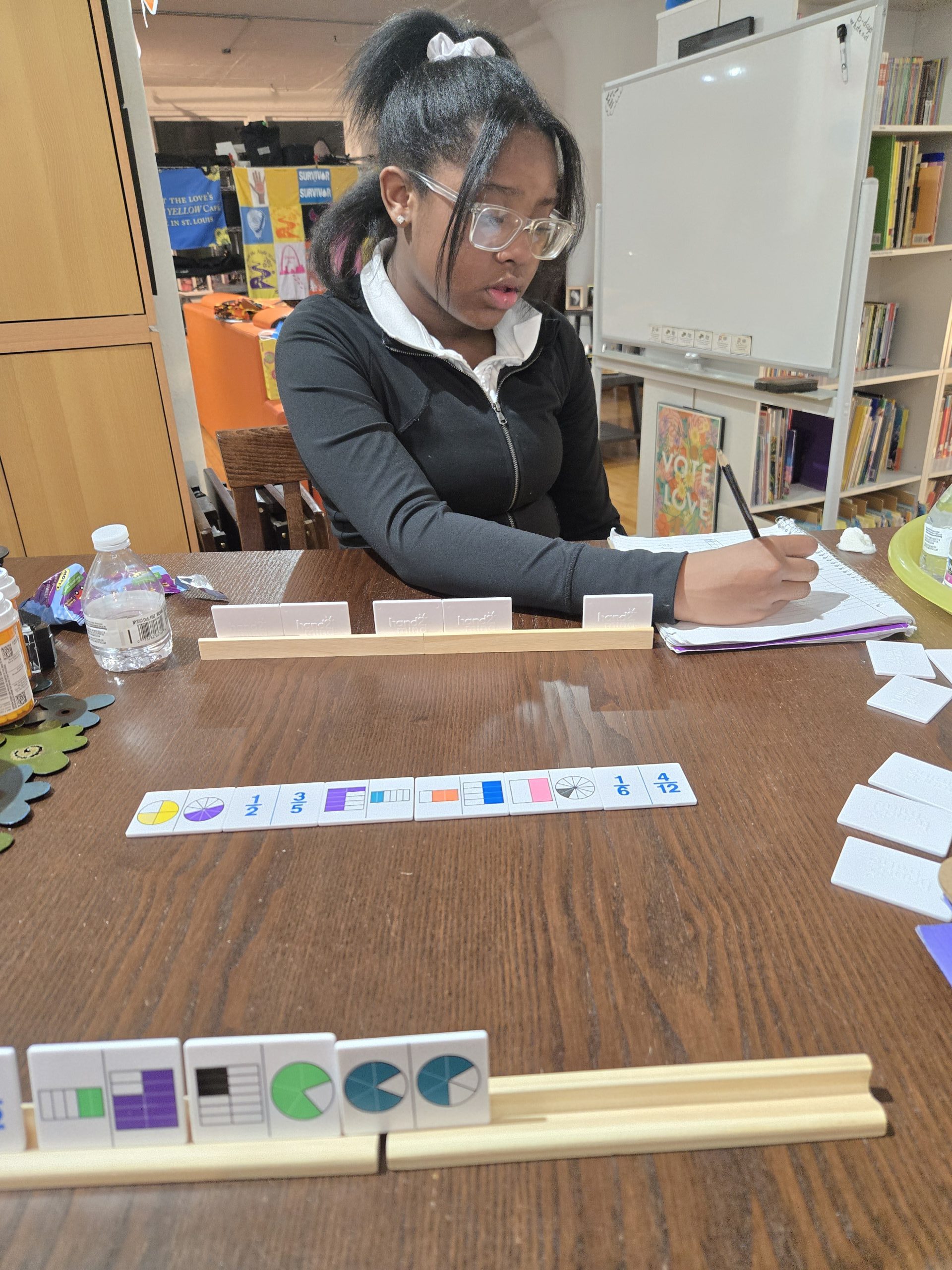 Middle school student solving fraction problems during individualized tutoring session at ICYT