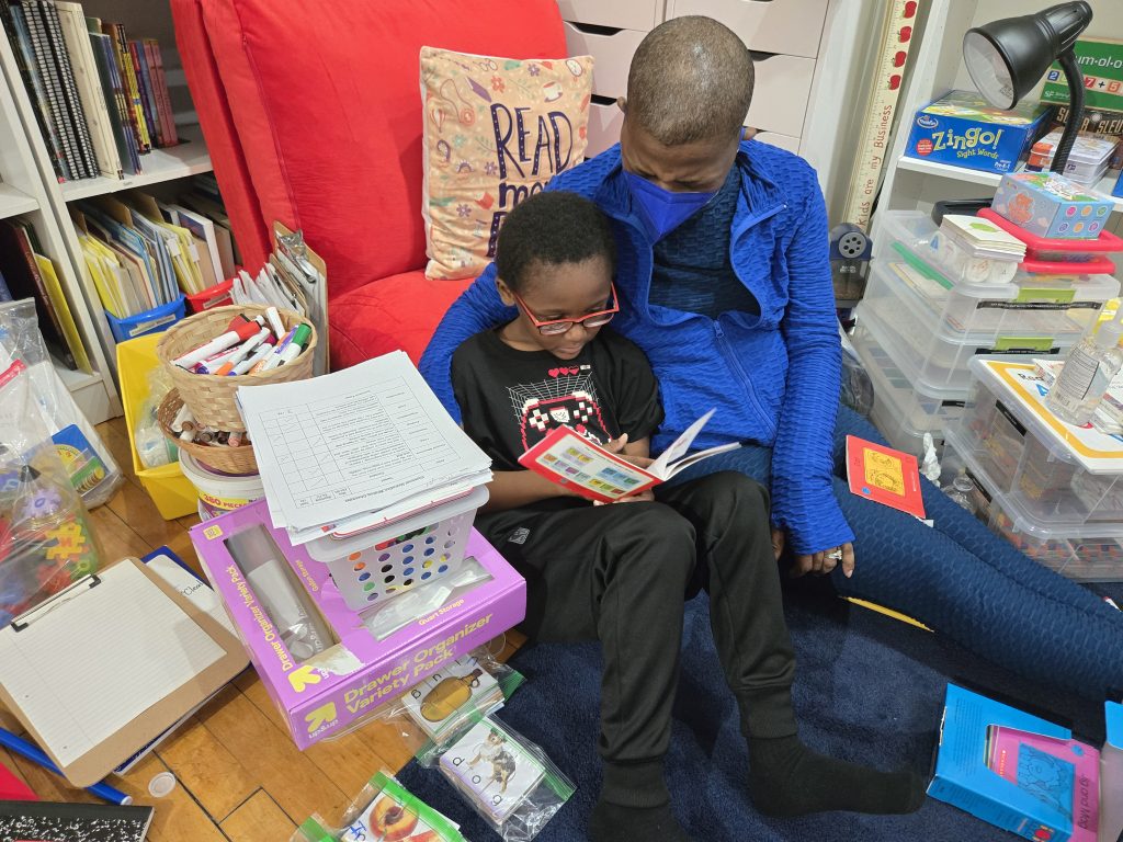 Tutor working one-on-one with student to improve reading skills in supportive learning environment