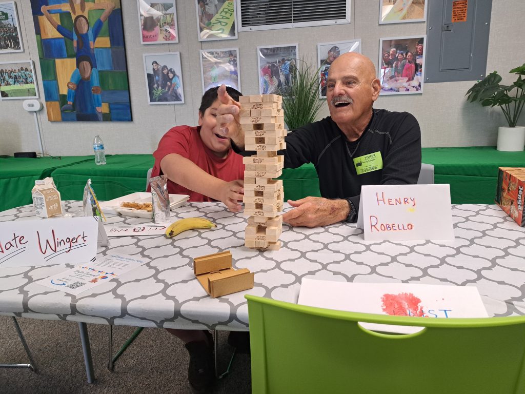 Mentor Student play Jenga Neighborhood Degree