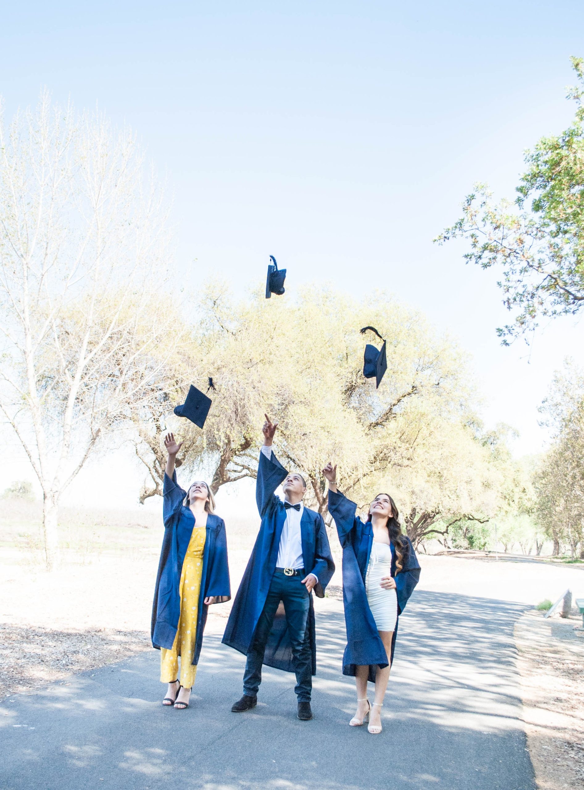 Neighborhood Degree grads toss mortarboards in air