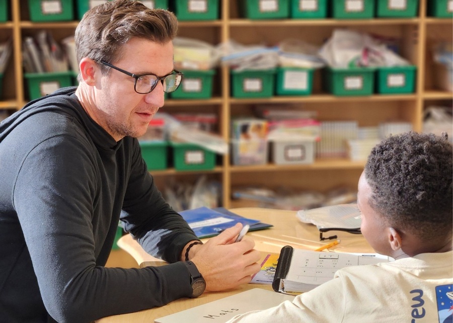 AR Kids Read male tutor works with young boy student