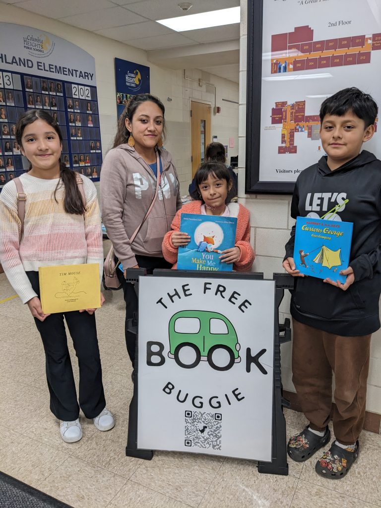 Students showing books received from The Free Book Buggie at Highland Elementary School
