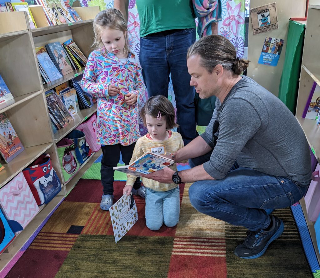 Children listening to a story during a visit to The Free Book Buggie