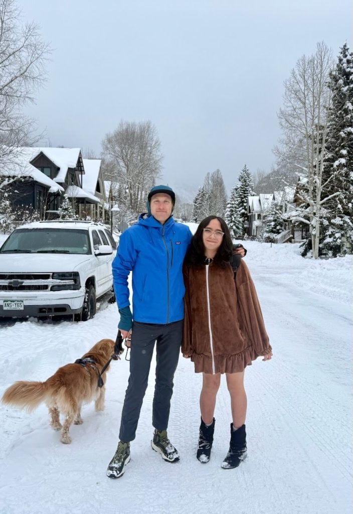 one to one mentoring male mentor female mentee walk dog in snow