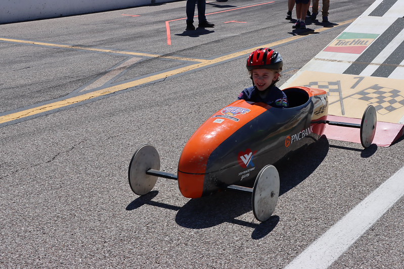 Greater St. Louis Area Scouting soap box derby helmeted driver 