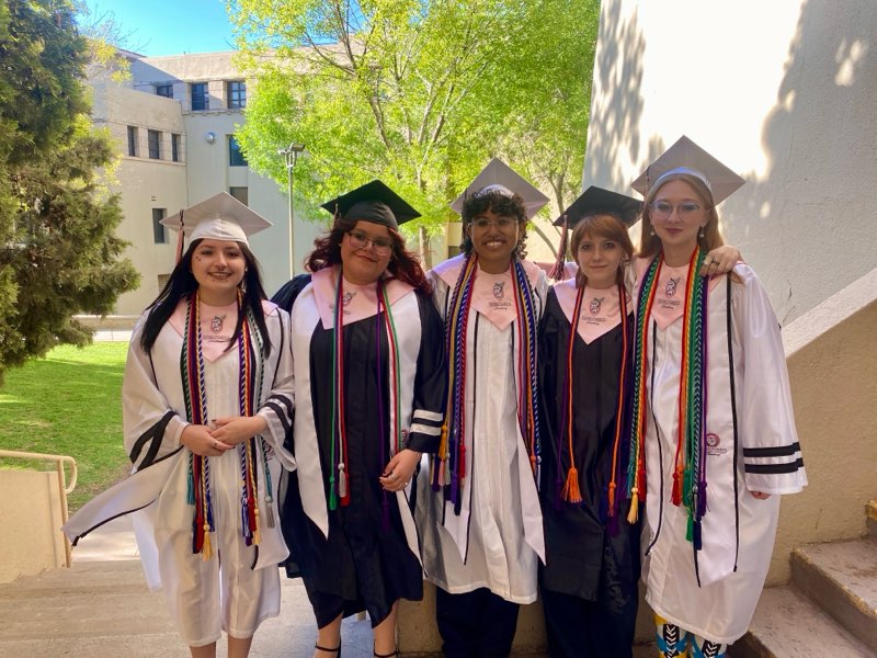 YWPN smiling grads capped and gowned