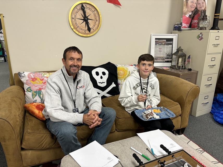 Male mentoring couple meet in lounge TeamMates of Glenwood