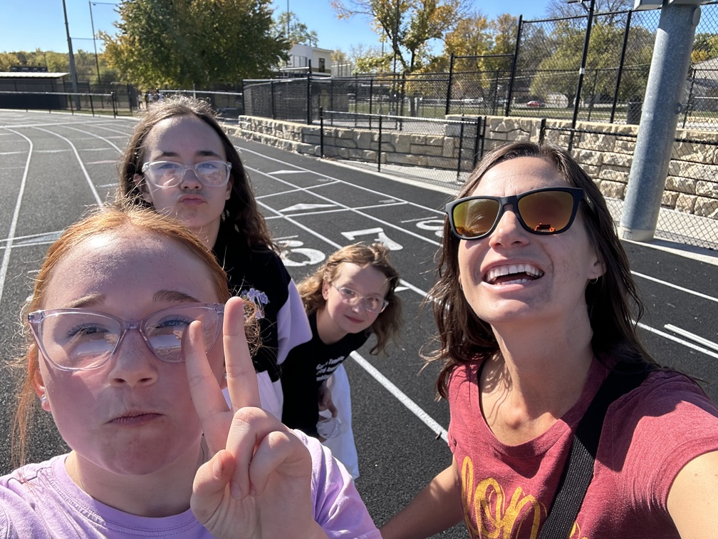 group photo girls on basketball court with female mentor