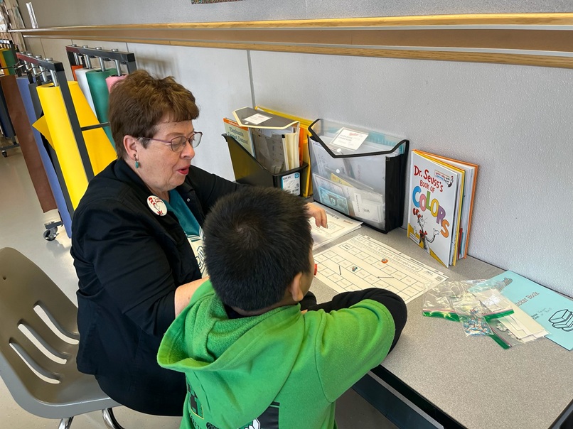 tutor works with young boy on literacy skills