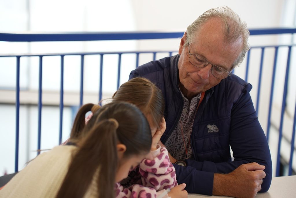 Read With Me male tutor with two young girls