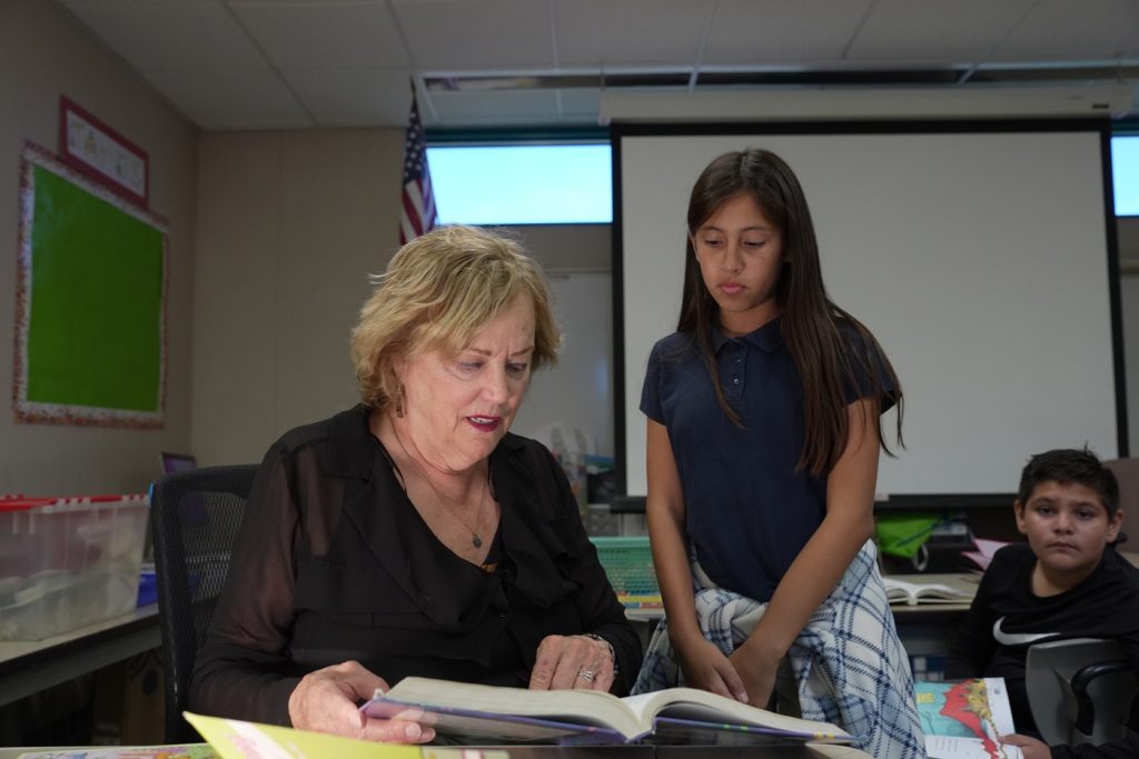 Middle school-aged girl works with volunteer tutor