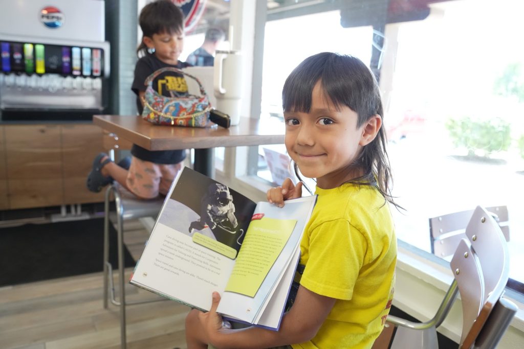 Girl with book about astronauts